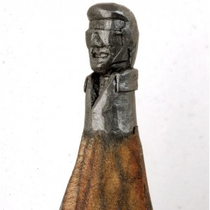A sculpture of Elvis Presley wearing shades, carved from a single pencil